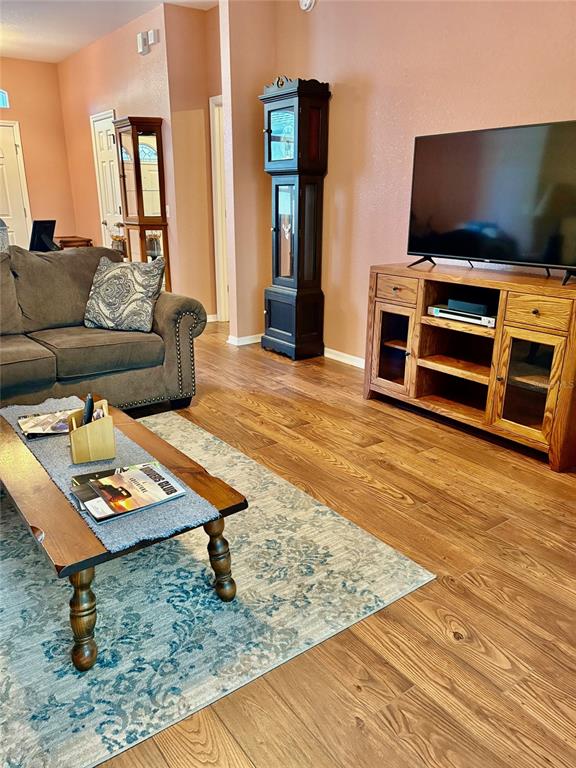 18970 Southwest 99th Street Dunnellon, FL 34432 - Photo 4 of 52 a living room with furniture and a flat screen tv