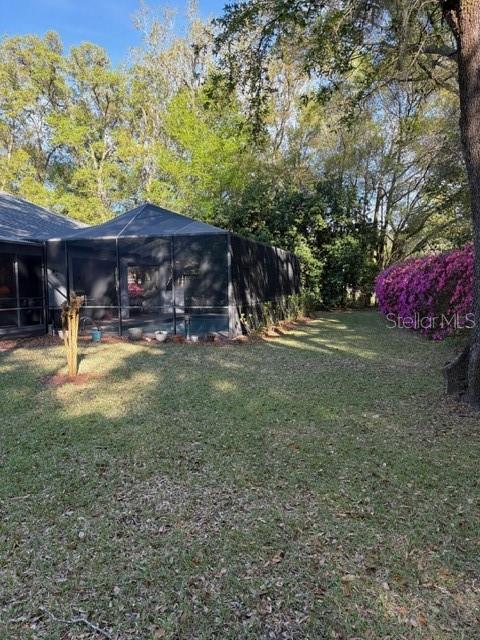 18970 Southwest 99th Street Dunnellon, FL 34432 - Photo 42 of 52 a view of a patio with table and chairs and a large tree