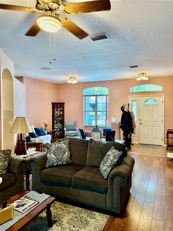 18970 Southwest 99th Street Dunnellon, FL 34432 - Photo 5 of 52 a living room with furniture and a chandelier
