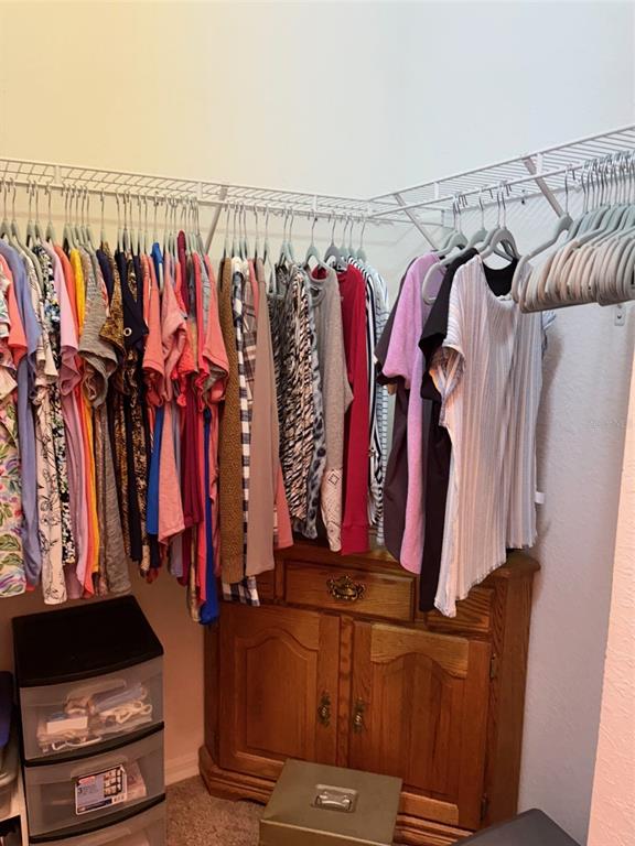 18970 Southwest 99th Street Dunnellon, FL 34432 - Photo 8 of 52 a view of walk in closet with clothes and shoes