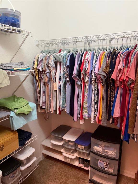 18970 Southwest 99th Street Dunnellon, FL 34432 - Photo 9 of 52 a view of walk in closet with clothes and shoes
