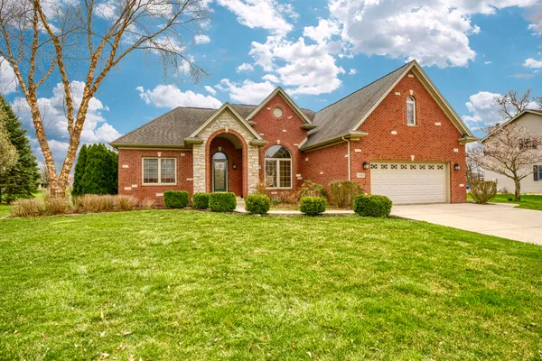 a front view of a house with a yard and garage