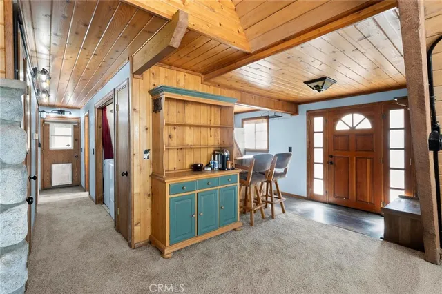 a kitchen with a sink a refrigerator and cabinets