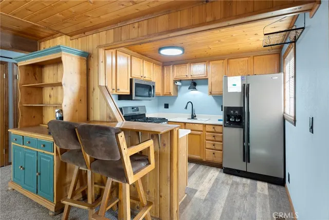 a kitchen with stainless steel appliances a stove refrigerator sink and cabinets