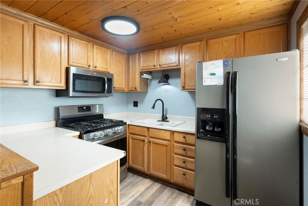 6069 Maple Avenue Angelus Oaks, CA 92305 - Photo 22 of 51 a kitchen with stainless steel appliances a stove refrigerator sink and cabinets