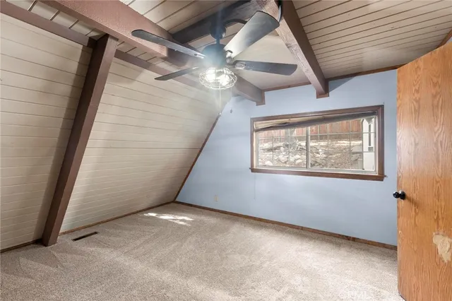 a view of a hallway with wooden shelves
