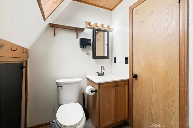 a bedroom with bed a computer on the desk and chair