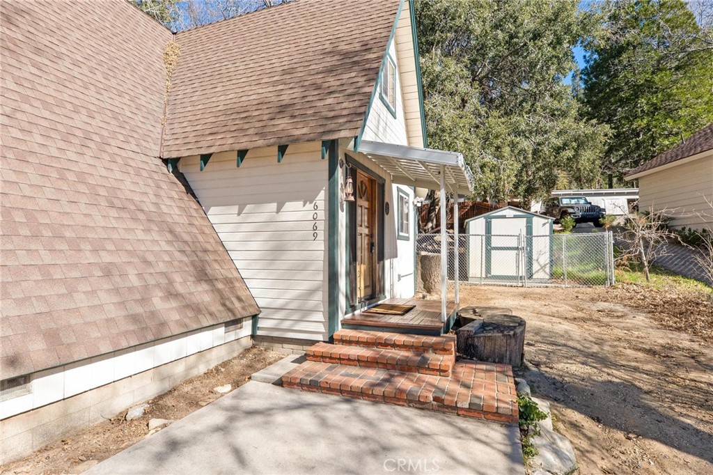6069 Maple Avenue Angelus Oaks, CA 92305 - Photo 9 of 51 a view of a patio with table and chairs and wooden fence