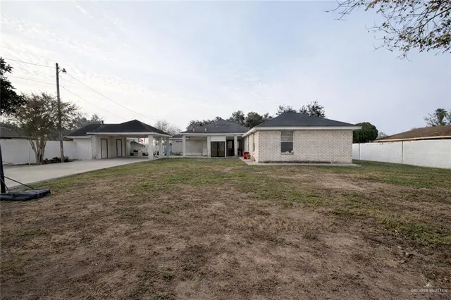 a view of a house with a backyard