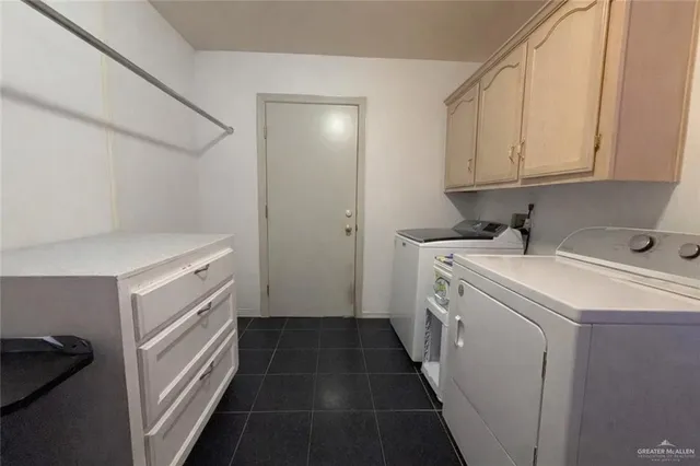 a utility room with sink dryer and washer