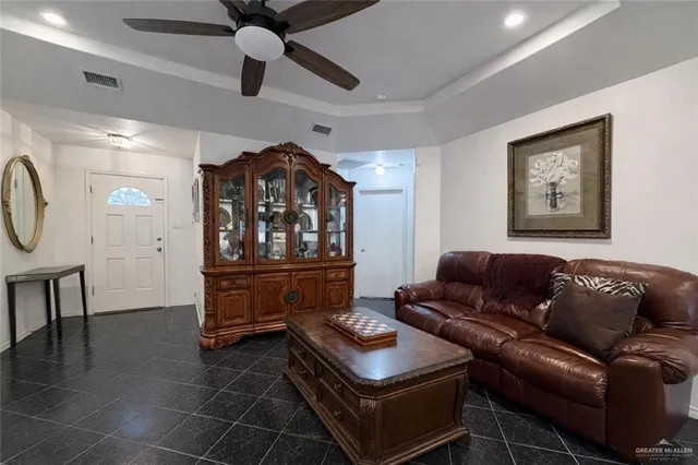 a living room with furniture a air conditioner vent and a window