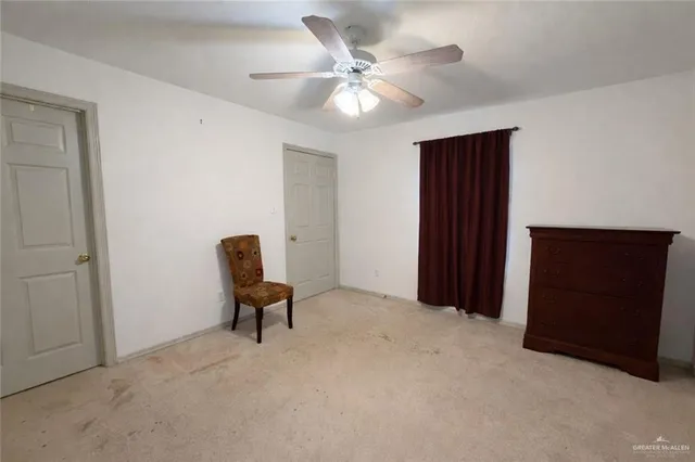 a hallway with furniture and a ceiling fan