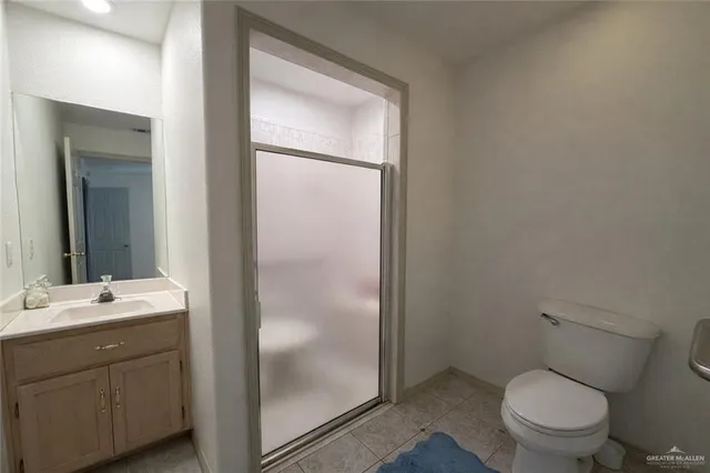 a bathroom with a toilet a sink and a mirror