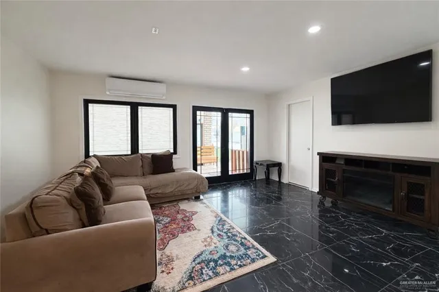 a living room with furniture a flat screen tv and a fireplace