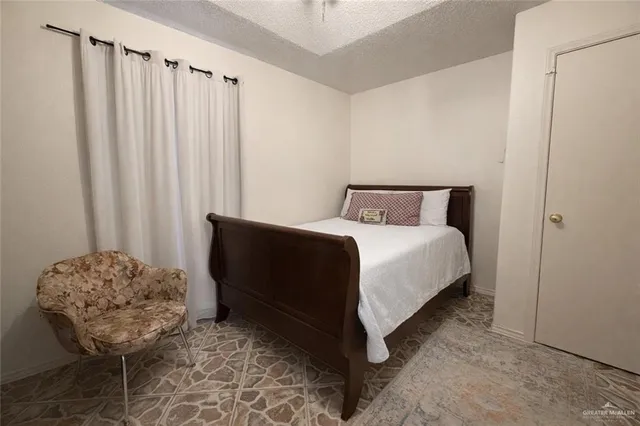 a bedroom with a bed and a chair