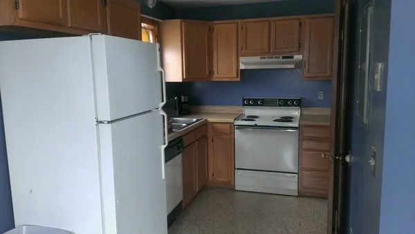 a white refrigerator freezer sitting in a kitchen