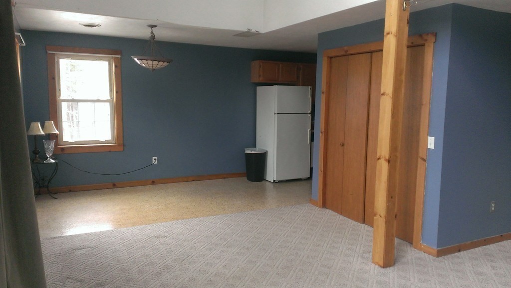 191 City Depot Road, Unit B Charlton, MA 01507 - Photo 4 of 12 an empty room with windows and closet
