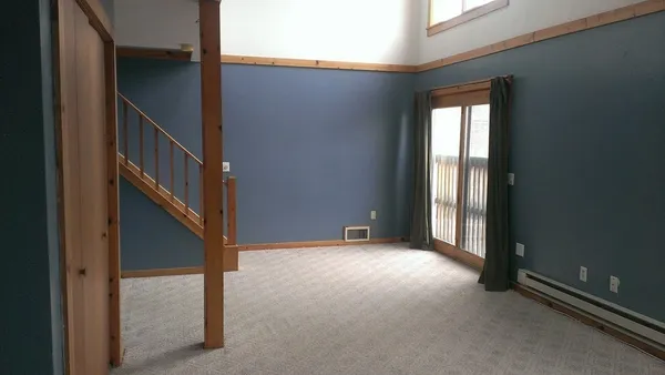 a view of an empty room with stairs