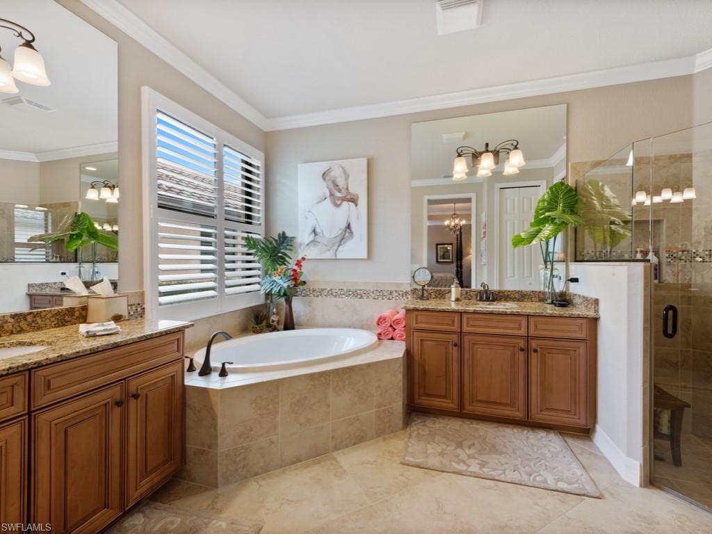 9507 Piacere Way Naples, FL 34113 - Photo 12 of 32 a spacious bathroom with a tub sink and mirror