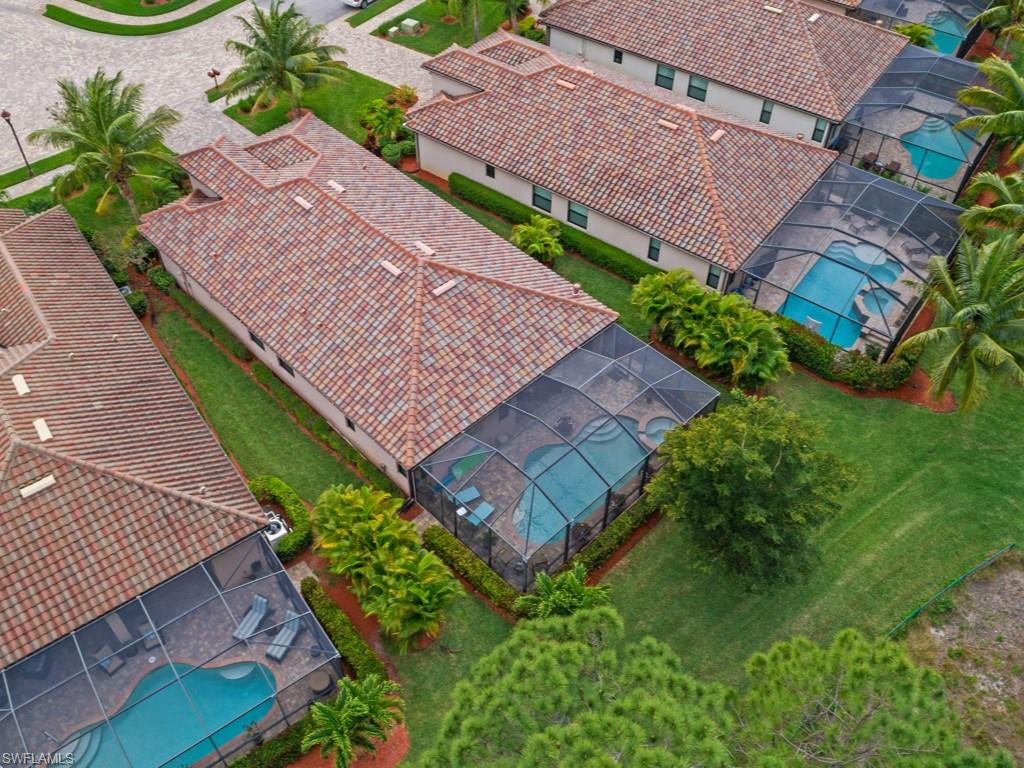 9507 Piacere Way Naples, FL 34113 - Photo 22 of 32 an aerial view of a house with garden space and street view