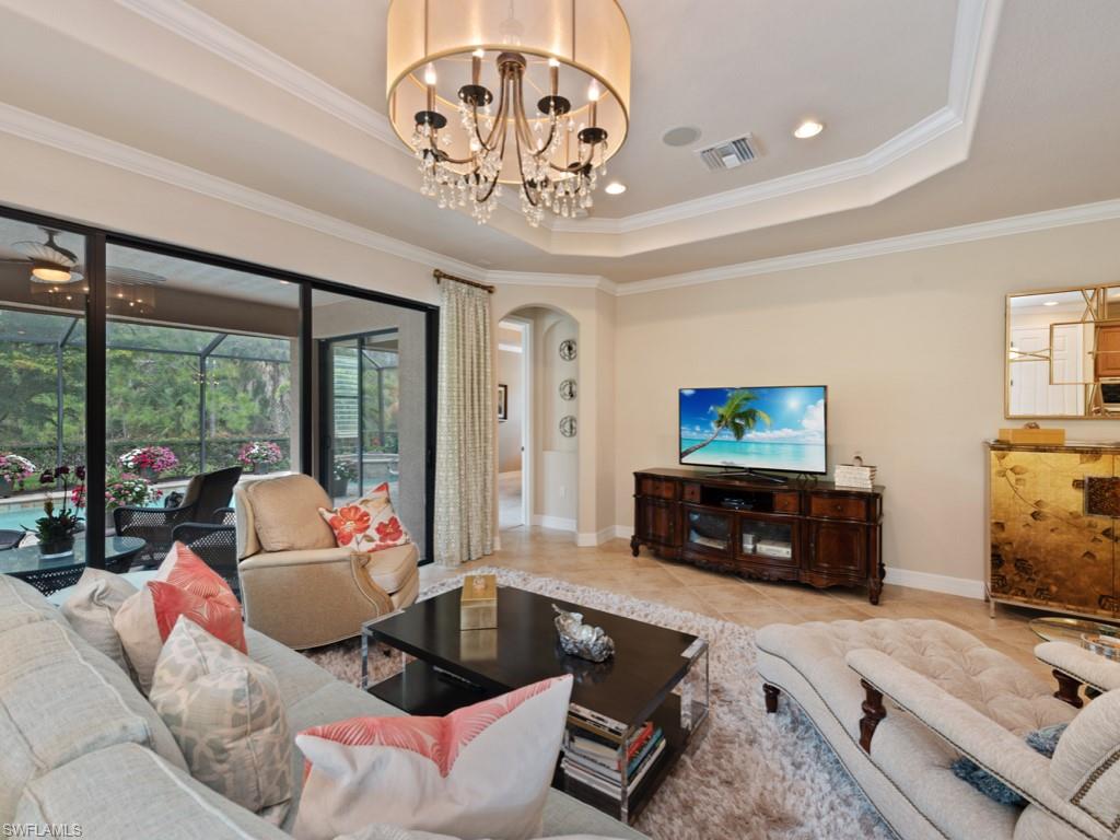 9507 Piacere Way Naples, FL 34113 - Photo 5 of 32 a living room with furniture and a flat screen tv