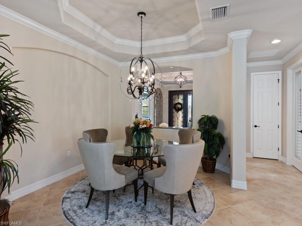 9507 Piacere Way Naples, FL 34113 - Photo 7 of 32 a view of a dining room with furniture a chandelier and wooden floor