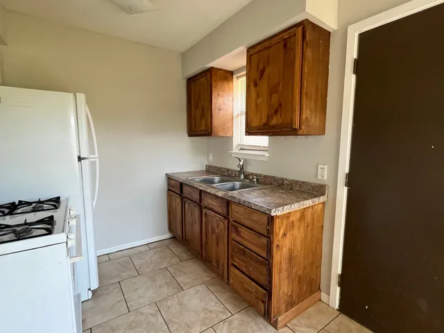 a kitchen with a stove and a refrigerator