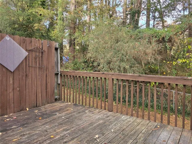 a view of balcony with wooden floor and fence