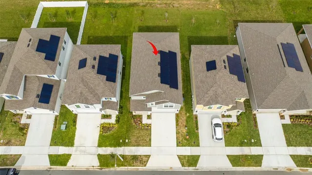 an aerial view of residential houses with outdoor space