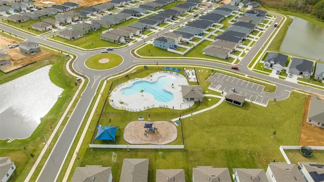 an aerial view of a house with a swimming pool