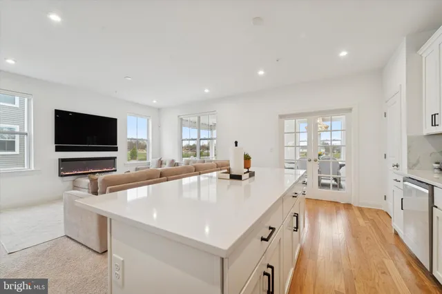 a living room with furniture a flat screen tv and a window