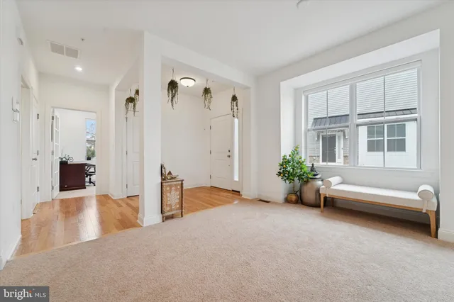 a living room with furniture and flowers