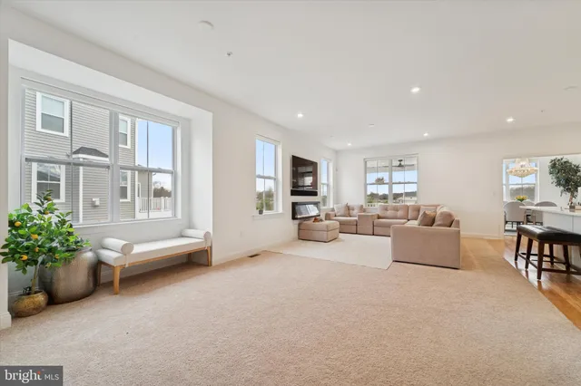 a dining room with furniture a chandelier and a rug
