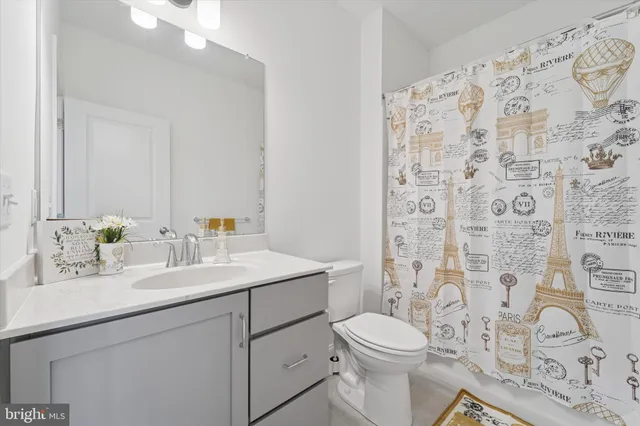 a bedroom with a bed and white cabinets