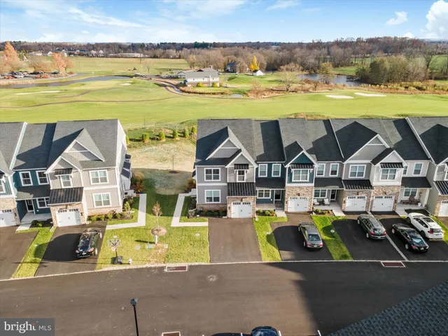 a kitchen with white cabinets a sink dishwasher and a stove with wooden floor