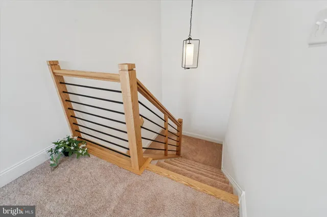 a bedroom with furniture and a chandelier fan