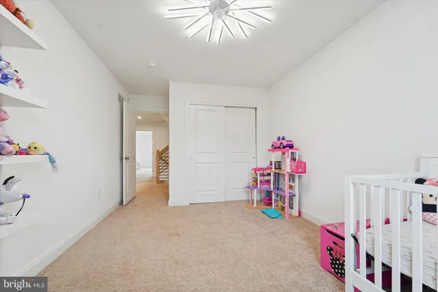 a living room with furniture a red couch and gym equipment