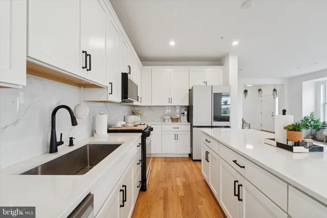 a kitchen with stainless steel appliances a stove a microwave and cabinets