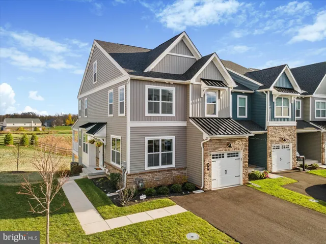 a aerial view of a house with a yard and balcony