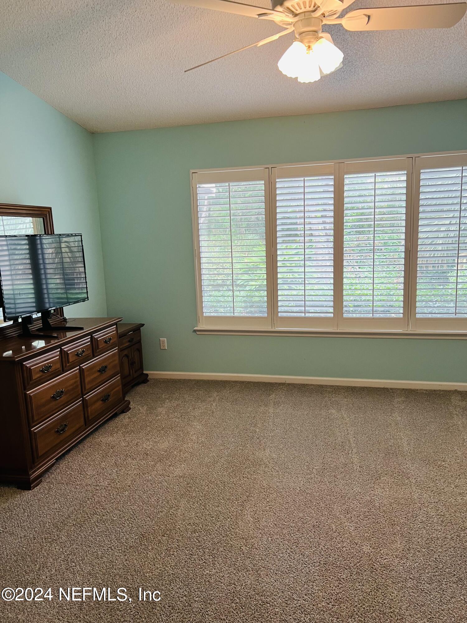 91 Fox Valley Drive Orange Park, FL 32073 - Photo 7 of 28 a living room with a bed furniture and a large window