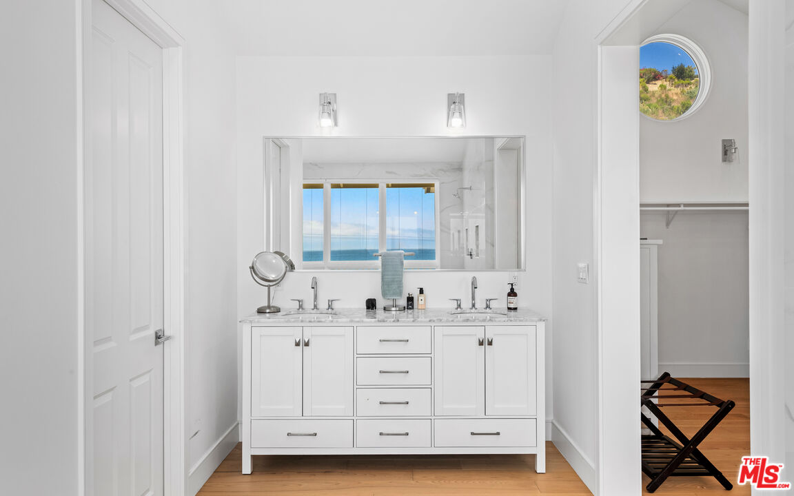 25157 Malibu Road Malibu, CA 90265 - Photo 14 of 33 a bathroom with a double vanity sink and a mirror