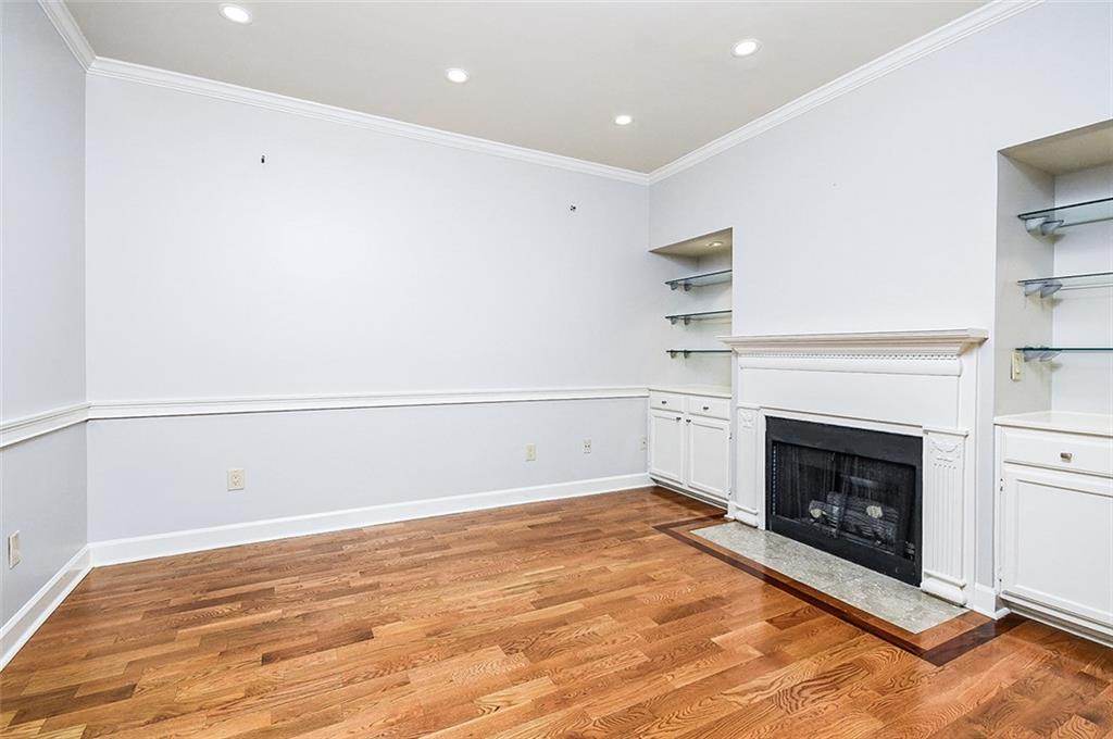 2865 Lenox Road Northeast, Unit 407 Atlanta, GA 30324 - Photo 24 of 27 a view of empty room with a fireplace and wooden floor