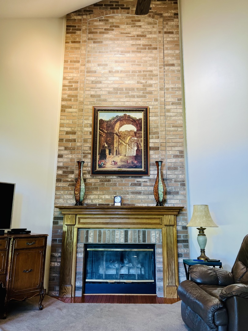 10087 Branch Road Rochelle, IL 61068 - Photo 6 of 27 a fireplace with a clock on top of it