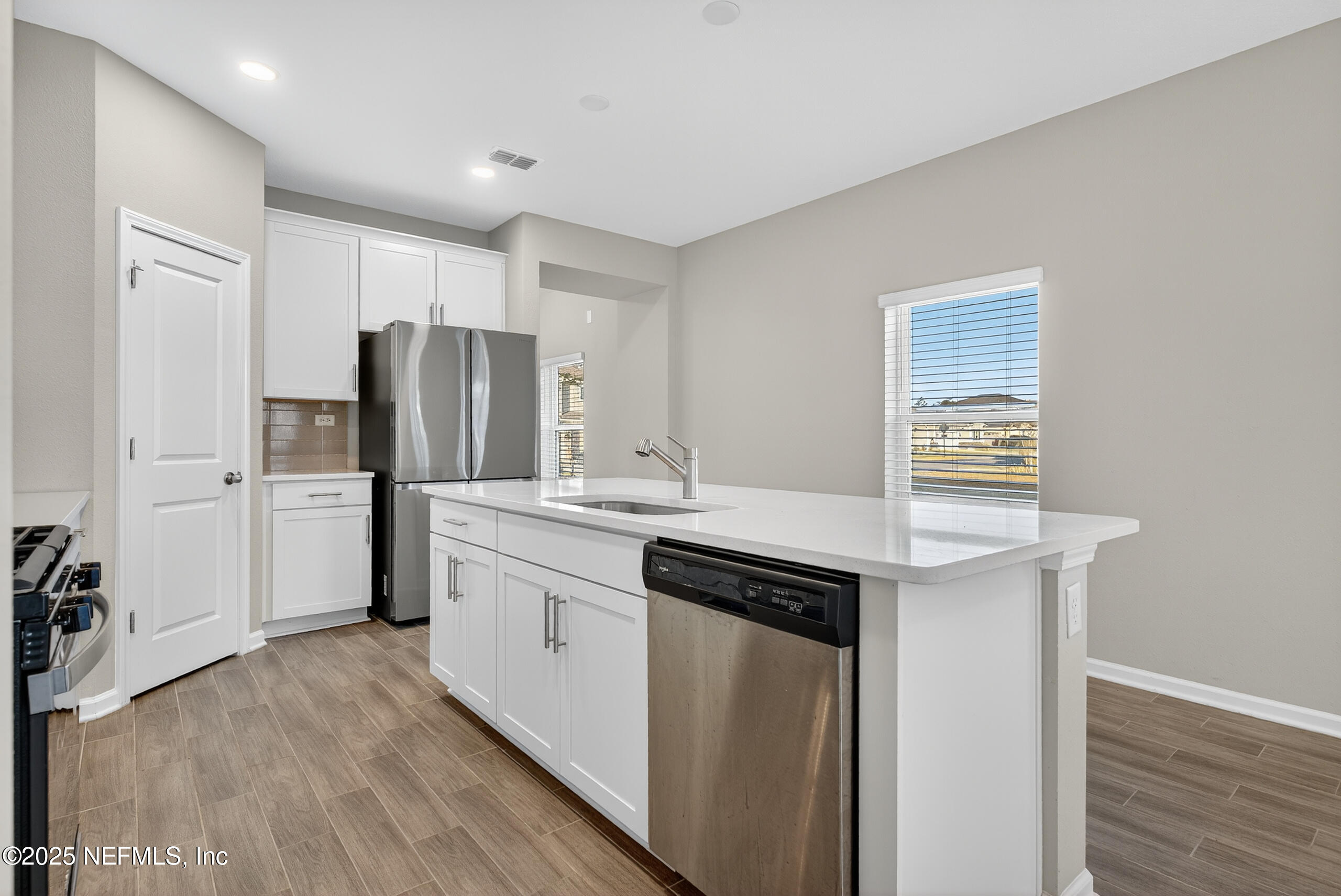 75598 Blackbird Drive Yulee, FL 32097 - Photo 13 of 30 a kitchen with stainless steel appliances a refrigerator and a stove