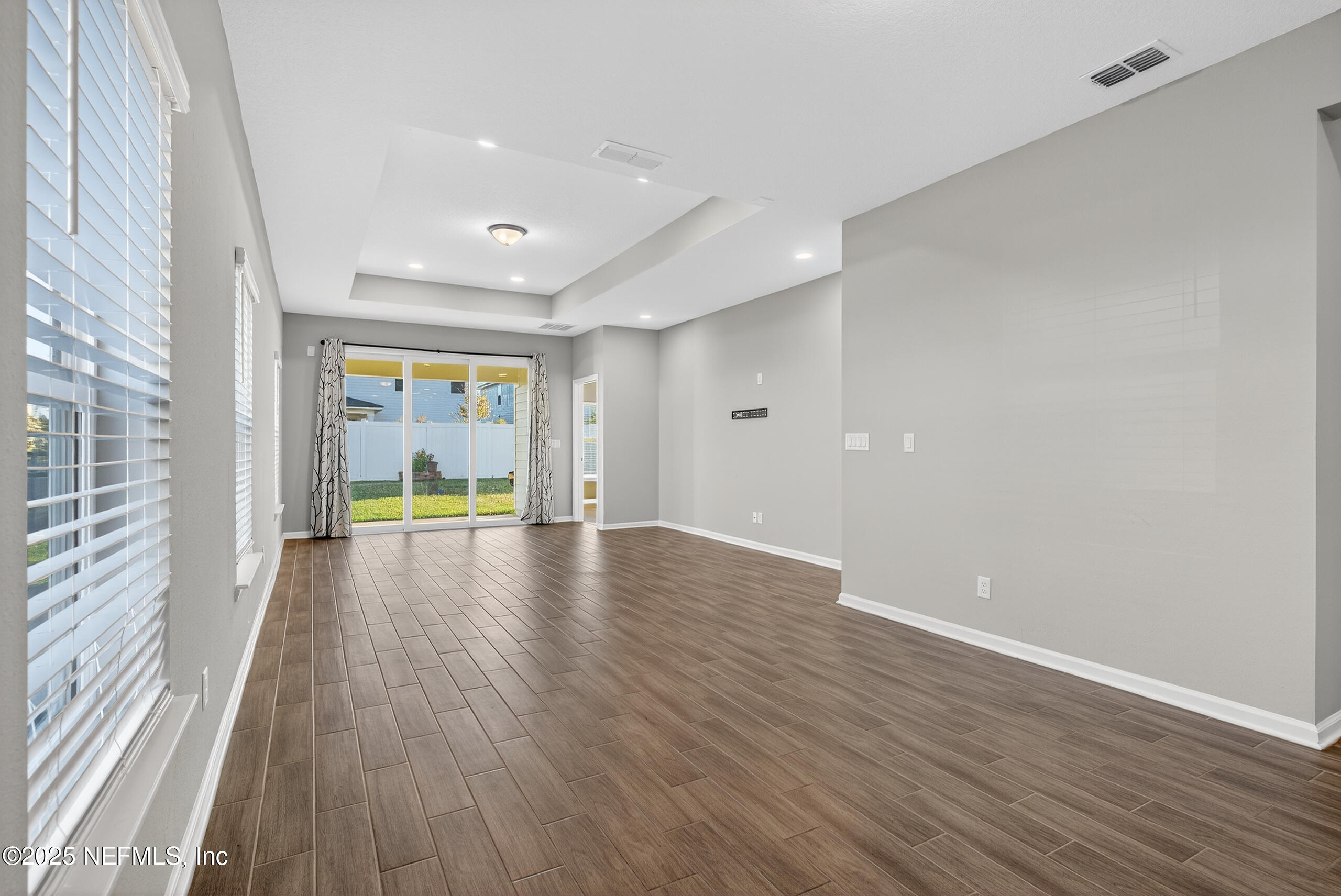 75598 Blackbird Drive Yulee, FL 32097 - Photo 14 of 30 a view of an empty room with wooden floor and a window