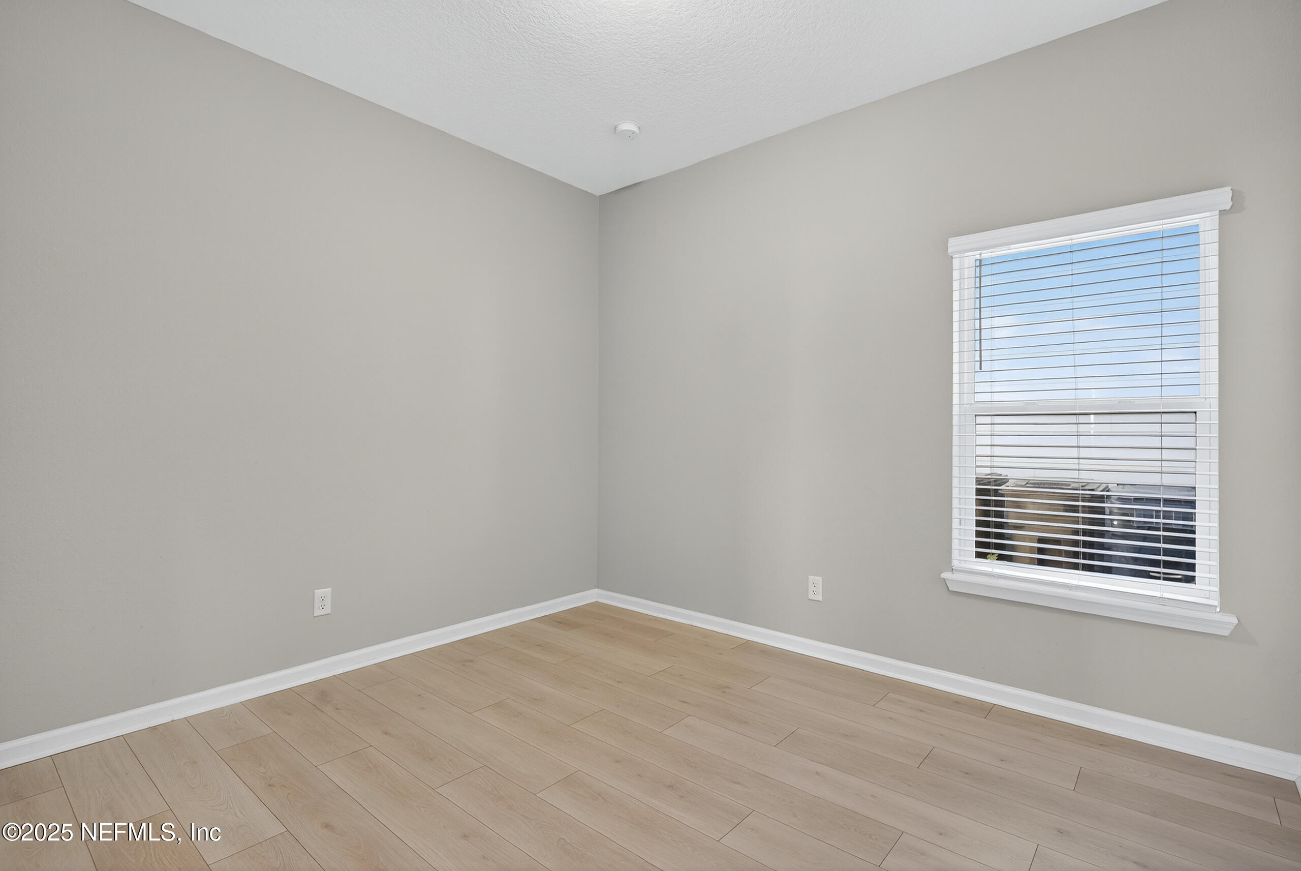 75598 Blackbird Drive Yulee, FL 32097 - Photo 21 of 30 a view of an empty room with wooden floor and a window