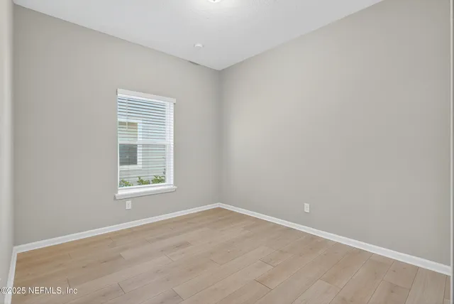 a view of a house with a big yard and potted plants