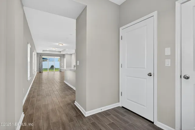 a kitchen with kitchen island white cabinets and stainless steel appliances