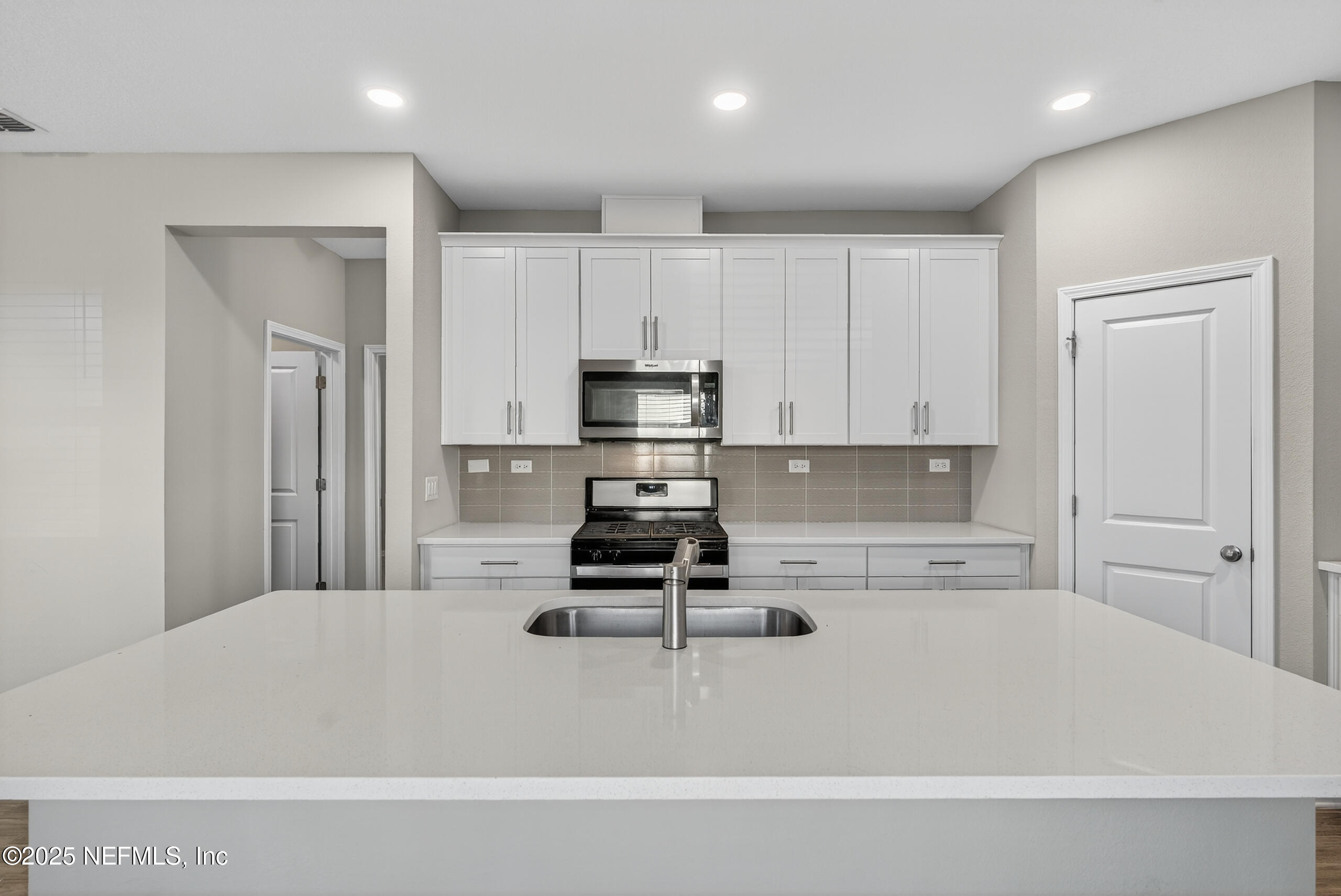 75598 Blackbird Drive Yulee, FL 32097 - Photo 9 of 30 a kitchen with kitchen island cabinets and refrigerator
