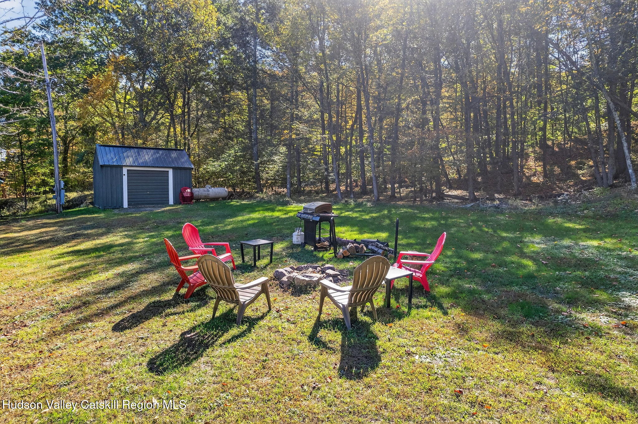 40 Paddock Road East Durham, NY 12423 - Photo 45 of 61 a wooden bench sitting in the middle of a yard